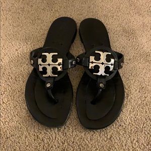 Black Tory Burch sandals with silver logo